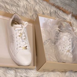 Used authentic Michael kors tennis shoes size 10 white/gold
